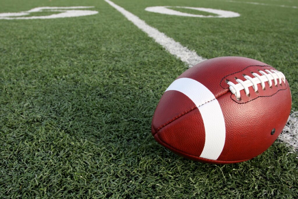 close up of american football on field