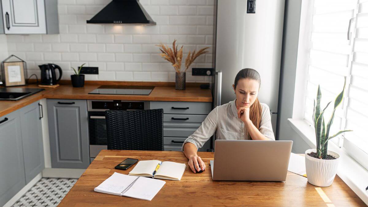 young woman working from home using laptop
